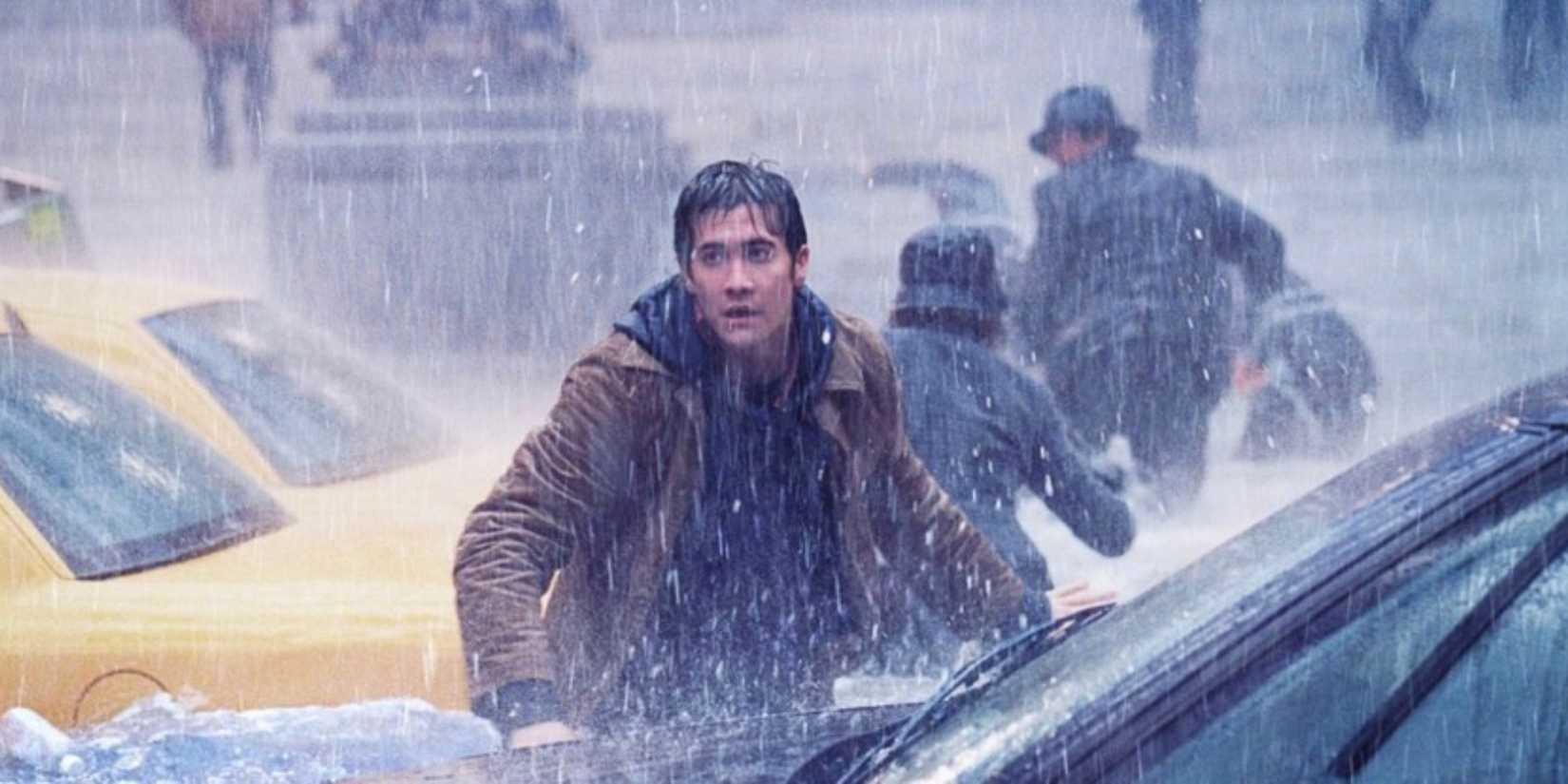 Jake Gyllenhaal wades through a flooded city street in heavy rain in 'The Day After Tomorrow'.