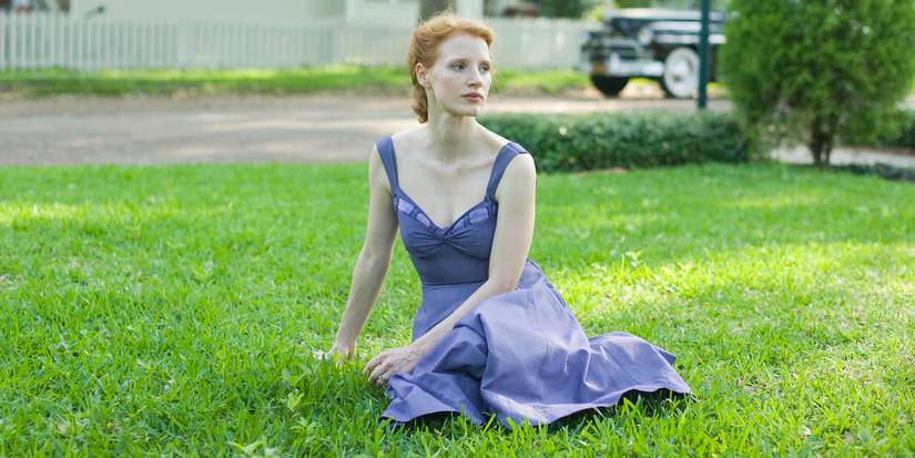 A woman laying on a garden looking to the distance in The Tree of Life