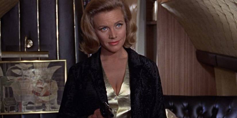 Pussy Galore wields a gun as she introduces herself to James Bond aboard a luxurious plane.