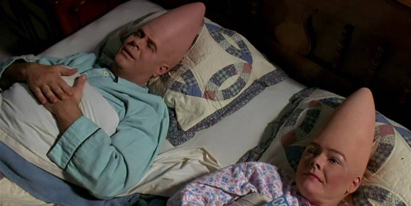 Dan Aykroyd and Jane Curtin as Beldar and Prymatt, in bed together in Coneheads.