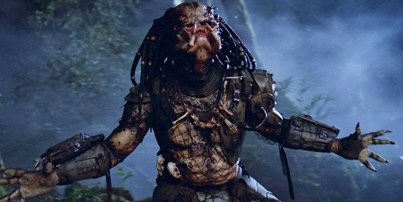 The Predator with its arms outstretched in the night forest.