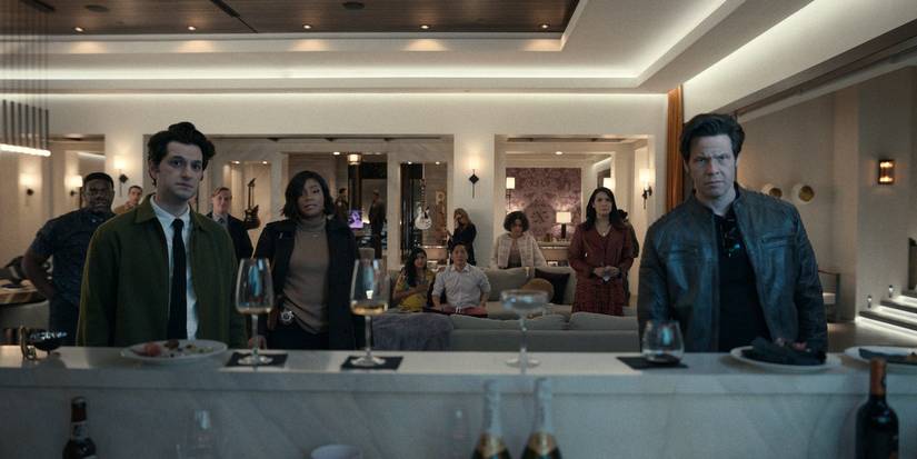 Members of the cast of The Afterparty stand in a living room looking at the camera.