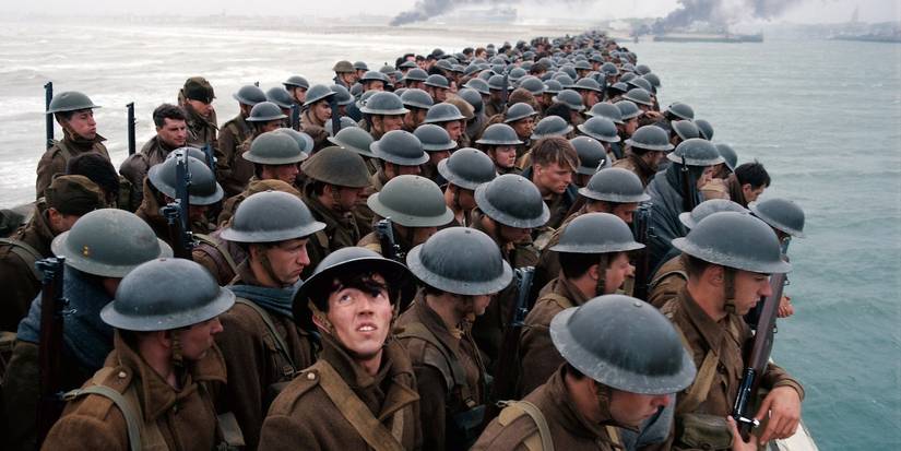 A young soldier looking up while in line with others in Dunkirk