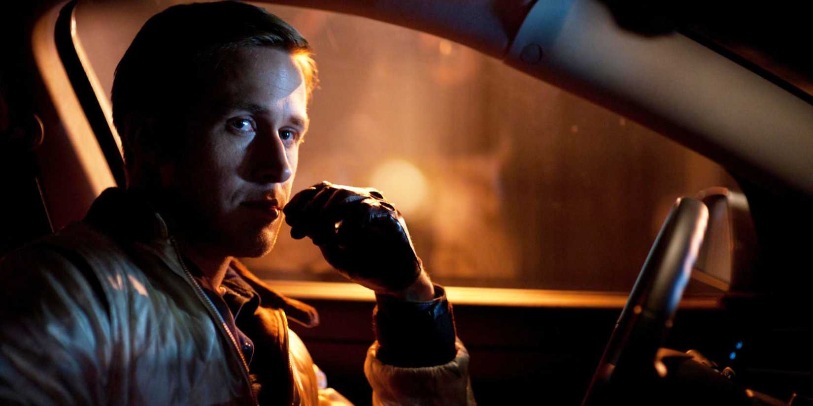 Ryan Gosling sits in a car at night and looks pensive in Drive.