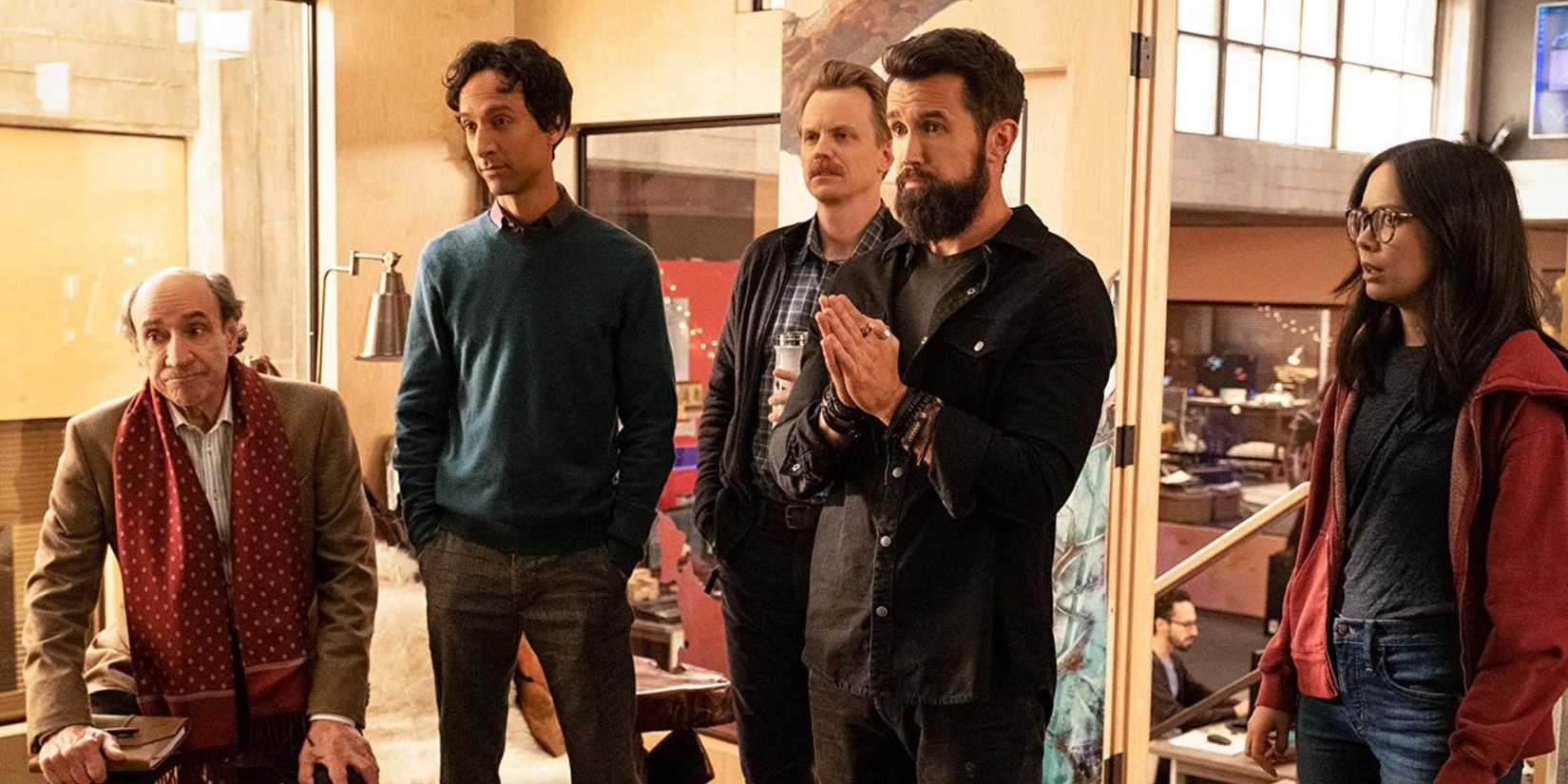 Carl (F. Murray Abraham), Brad (Dany Pudi), David (David Hornsby) ,Ian (Rob McElhenney) and Poppy (Charlotte Nicdao) staring at something offscreen in 'Mythic Quest'.