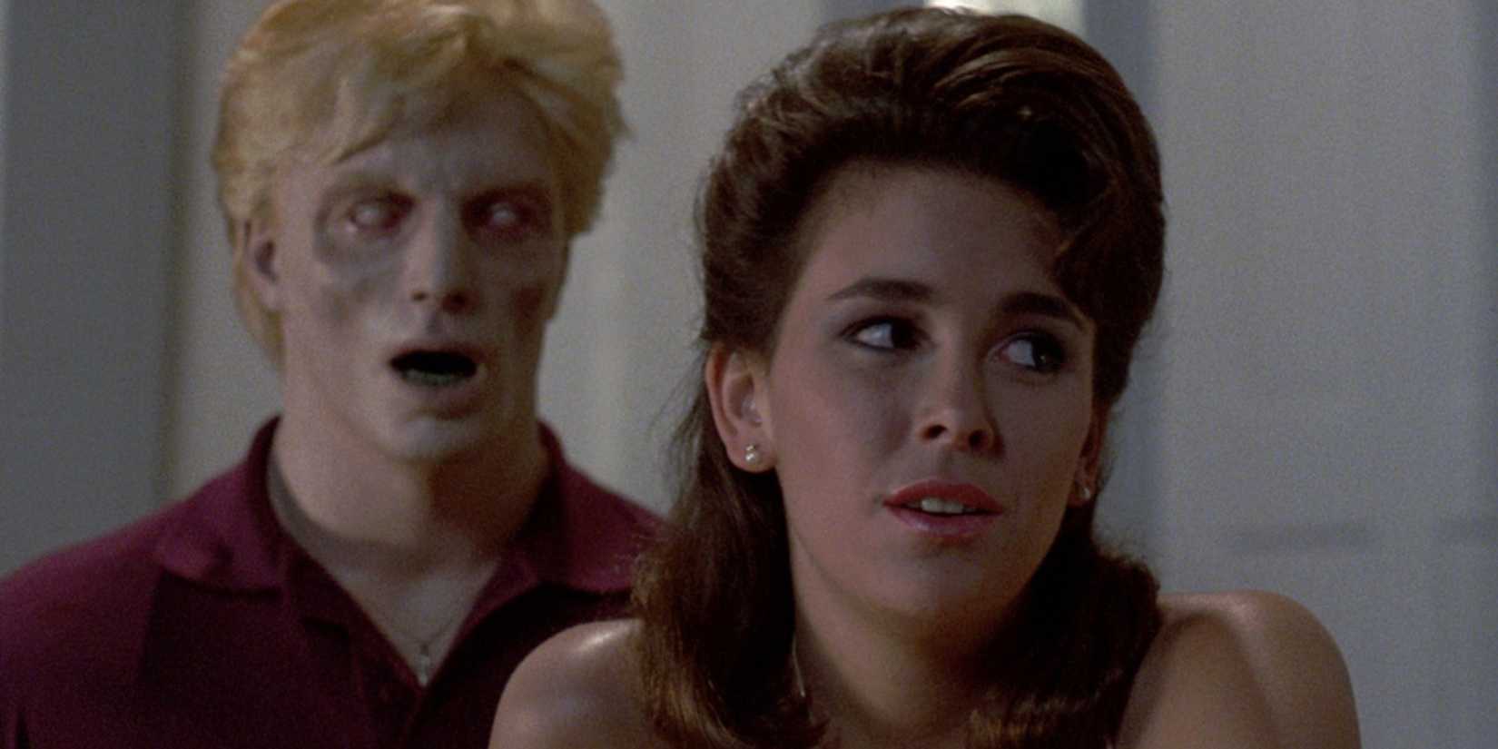 An undead standing behind a girl in Night of the Creeps