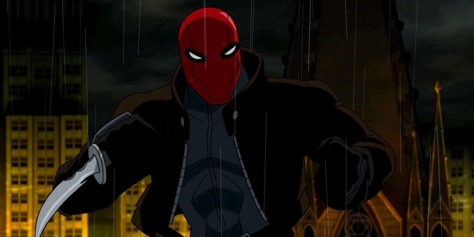 Red Hood under the rain fighting while holding a knife in Batman: Under the Red Hood.