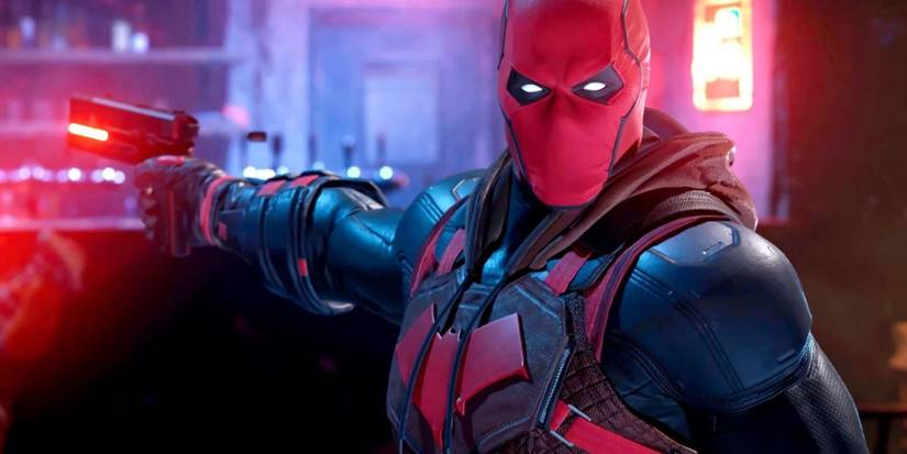 Batman supervillain, Red Hood in his costume, holding a hi-tech gun