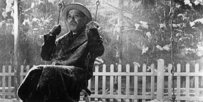 Takashi Shimura sitting on a swing in Ikiru