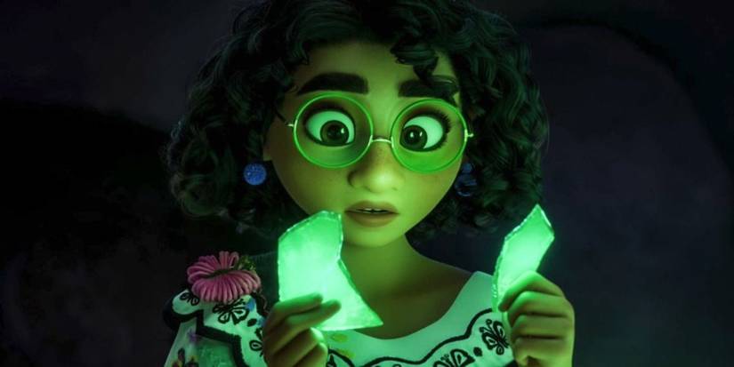 Mirabel, voiced by Stephanie Beatriz, stares at broken glowing fragments in Encanto.