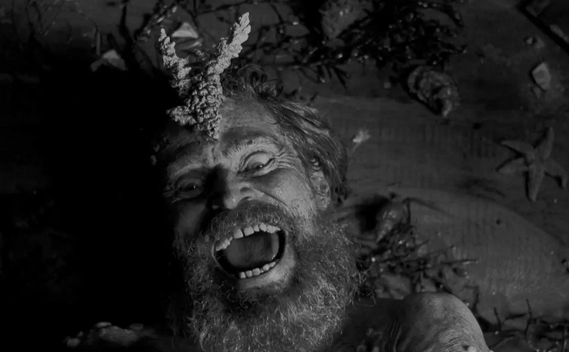The Lighthouse Willem Dafoe laughs in the sand