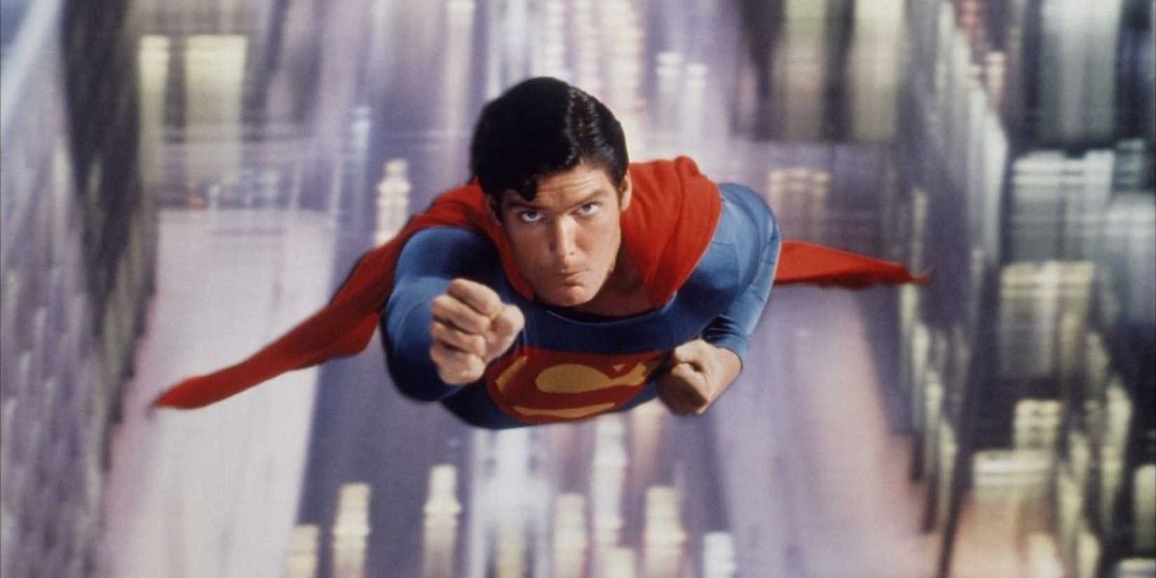 Christopher Reeve as Superman soaring above a city in Superman 1978.