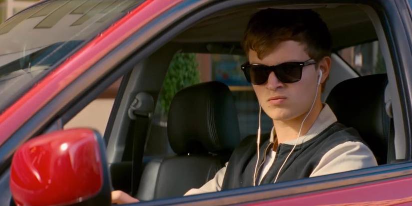 Bbay behind the wheel looking out the window in Baby Driver
