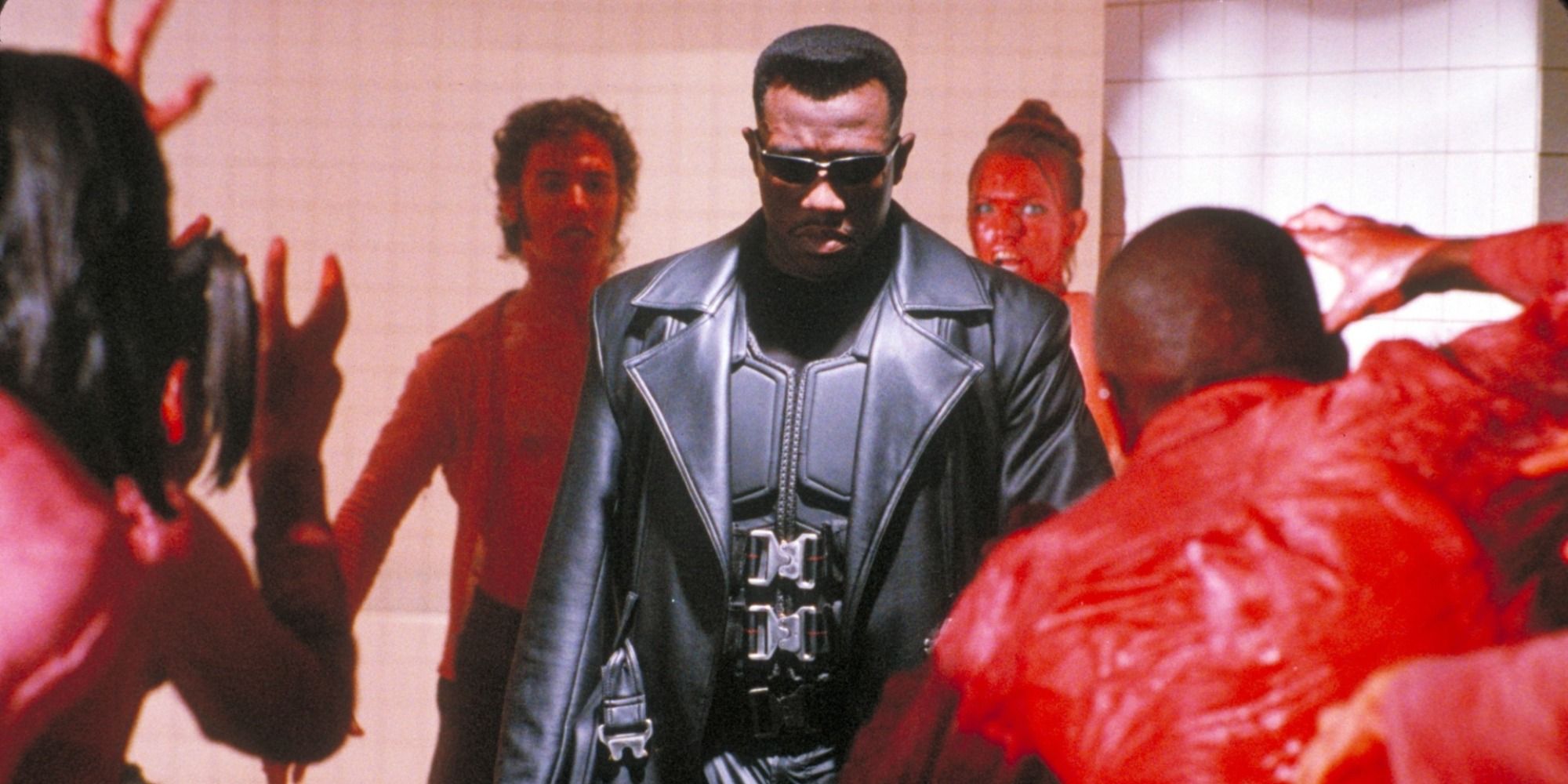 Blade surrounded by vampires covered in red blood. 
