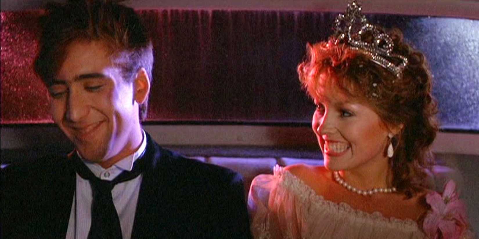 Nicolas Cage and Deborah Foreman as Randy and Julie sit in a car smiling in prom outfits in Valley Girl.