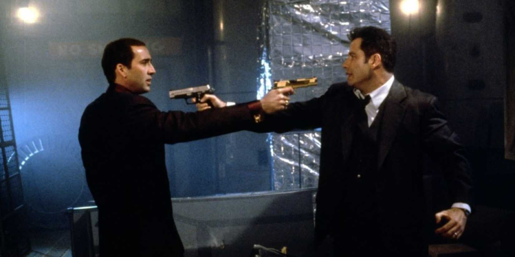 Nicolas Cage as Castor Troy and John Travolta as Sean Archer point guns at each other in a fight in Face/Off.