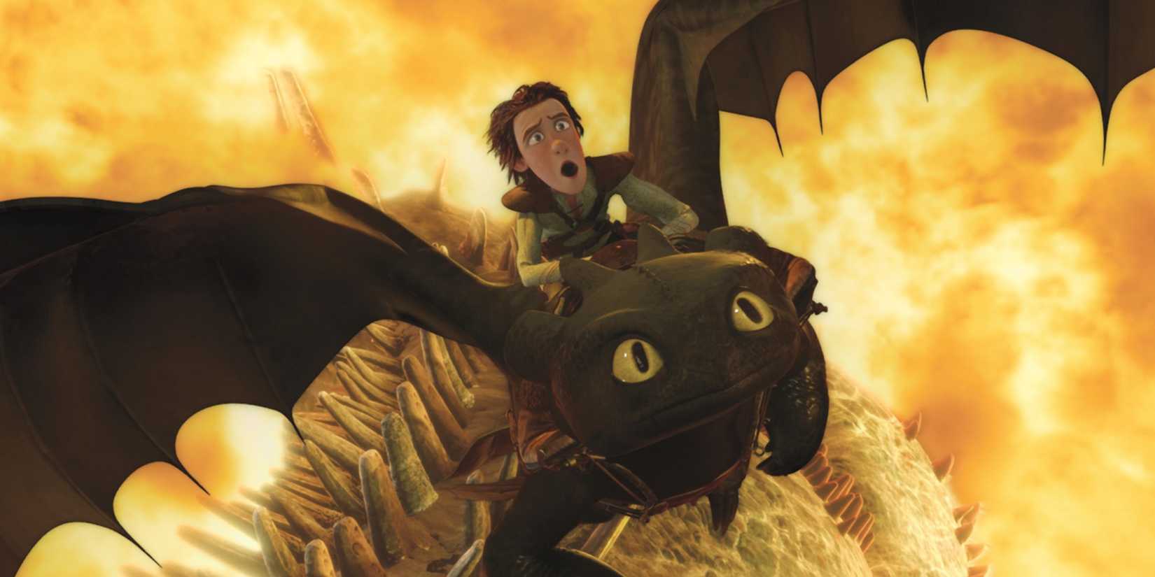 Hiccup flying on toothless with an explosion behind him in 'How To Train Your Dragon'.