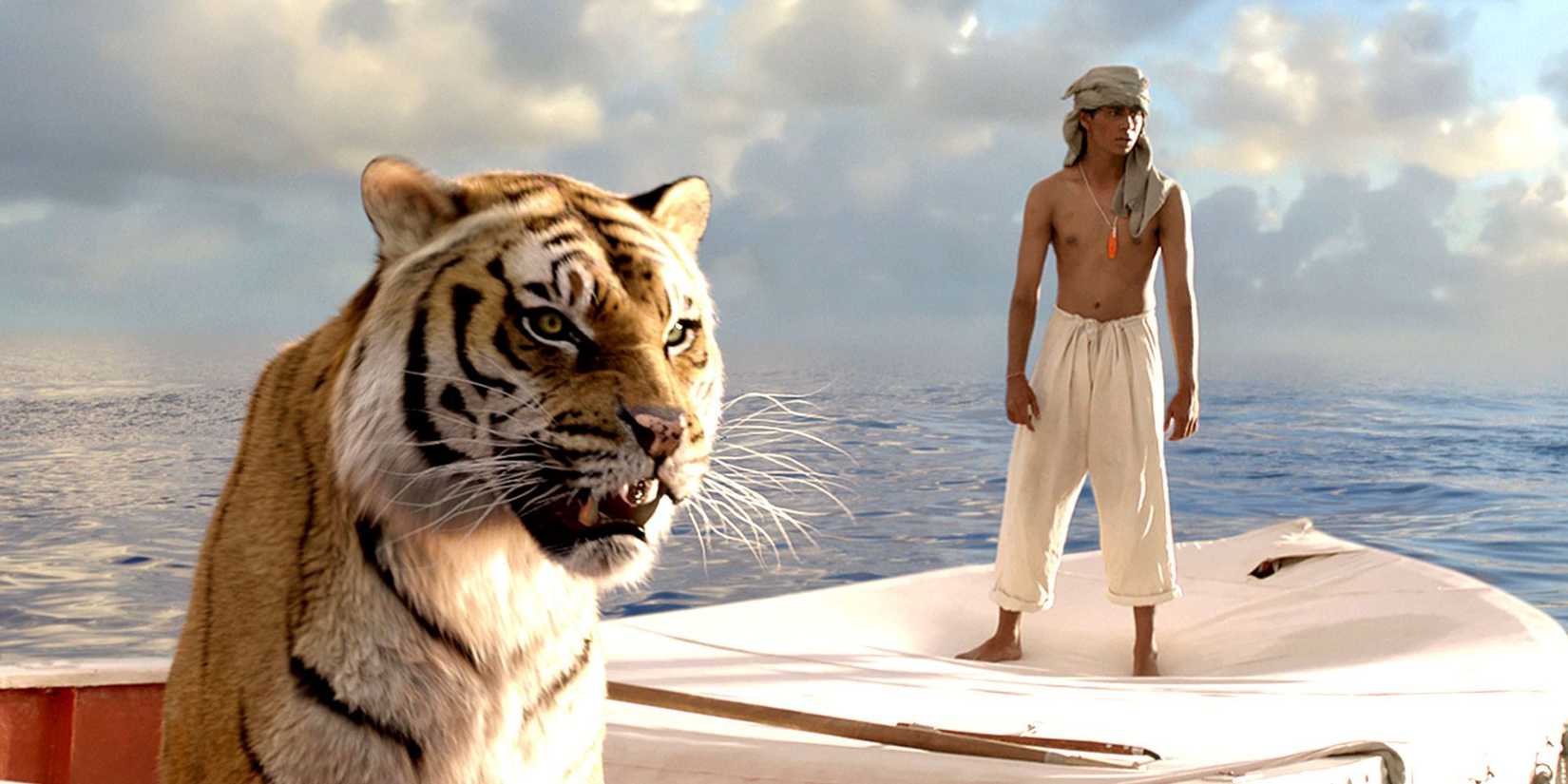 Pi Patel and the tiger standing aboard a ship at sea in Life of Pi