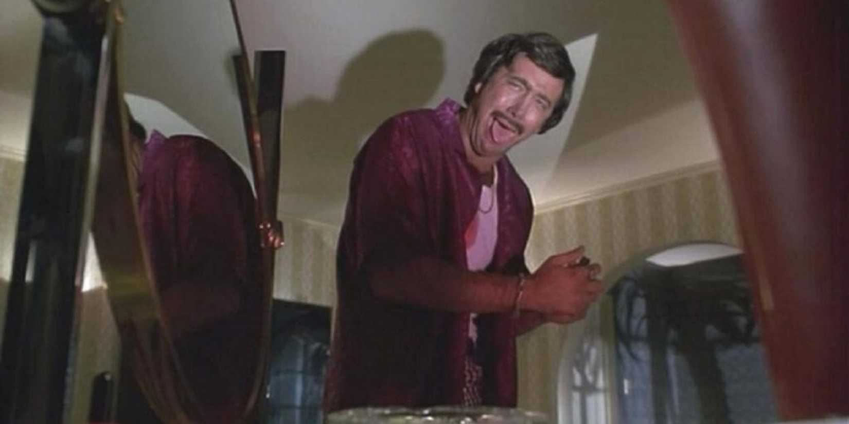 Nicolas Cage in Deadfall evilly laughing in hotel room cigar in hands