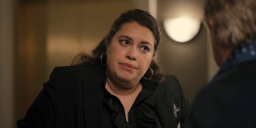 A woman in uniform is speaking to a man