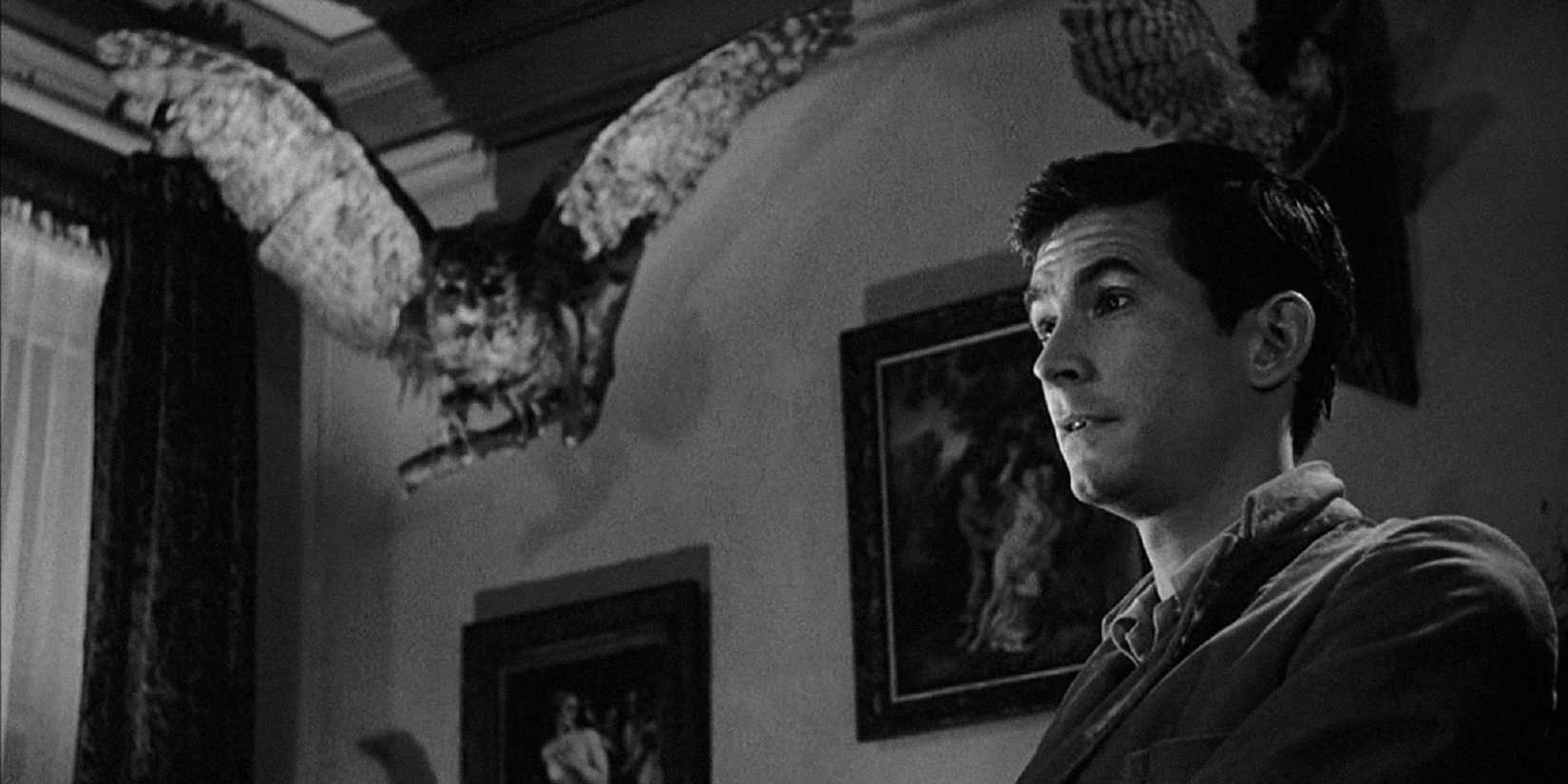 Norman Bates sits under a piece of his taxidermy in Psycho