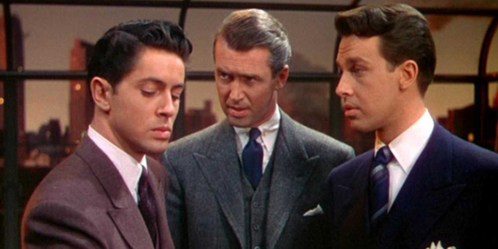 Three well dressed men have a tense conversation 