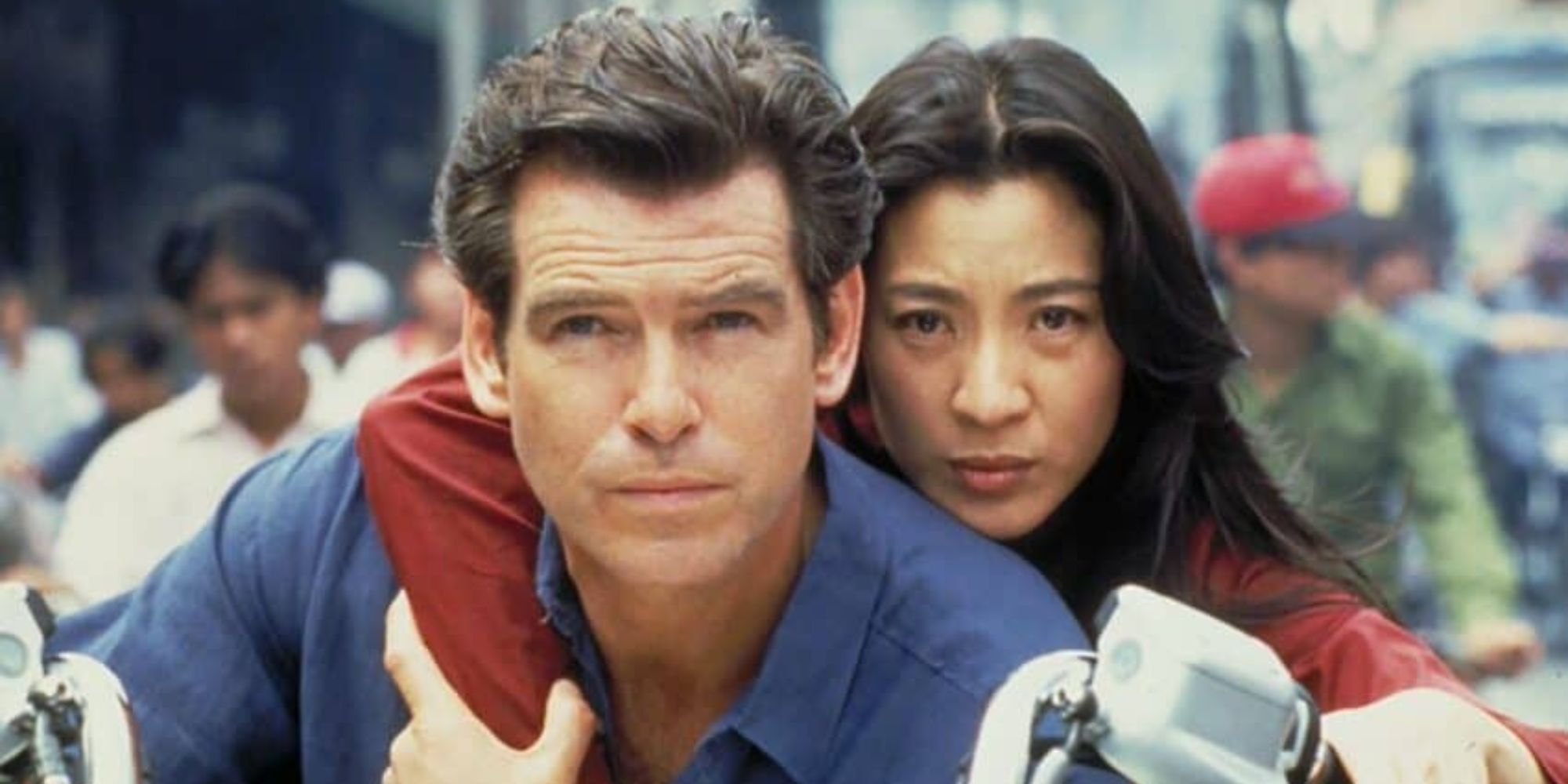 Pierce Brosnan as James Bond and Michelle Yeoh as Mai Lin on a motorbike in Tomorrow Never Dies