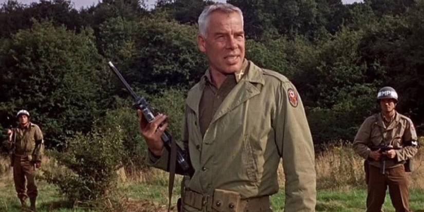 Lee Marvin as Major John Reisman in an open field holding a rifle in The Dirty Dozen