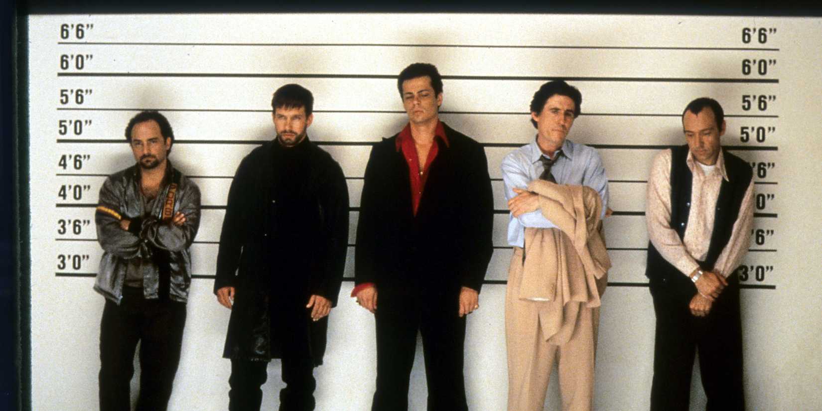 The characters of 'The Usual Suspects' stand annoyed in a police line-up.