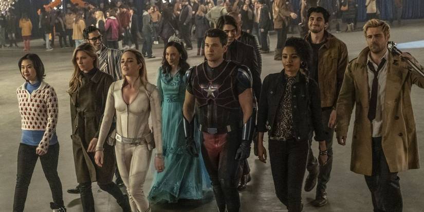 The superheroes from DC's Legends of Tomorrow smiling while walking as a group.