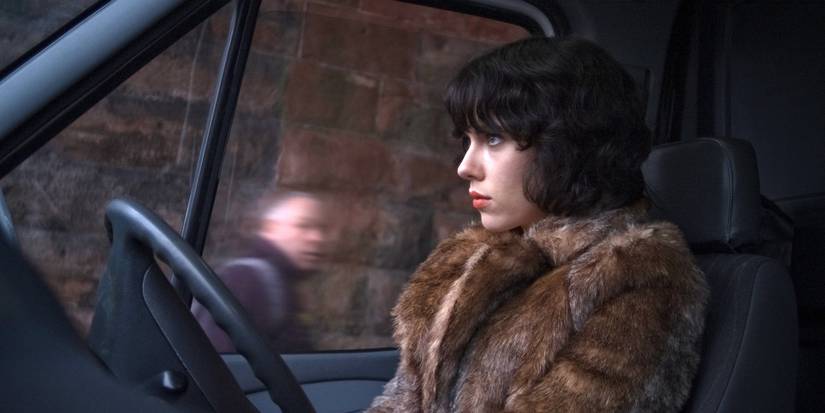 Scarlett Johansson inside a van looking intently ahead in Under the Skin