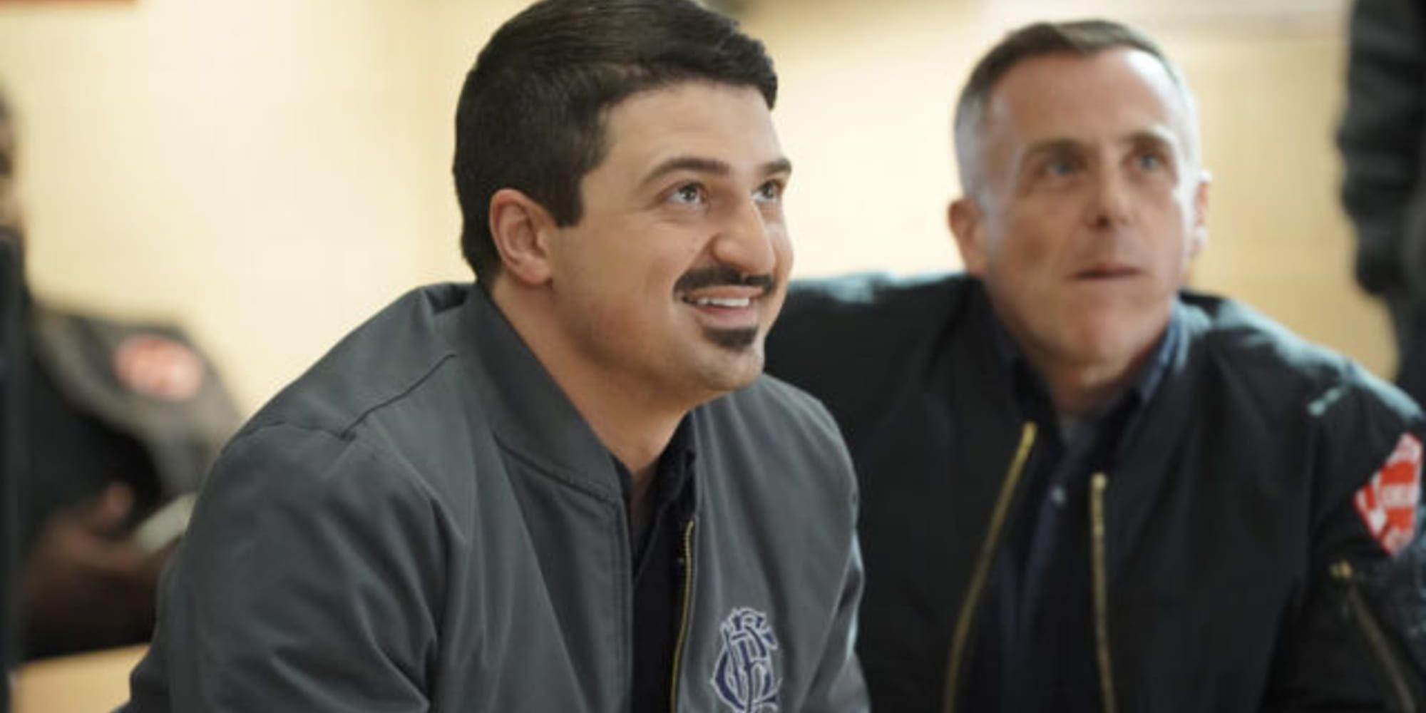 otis and herrmann from chicago fire smiling up at something