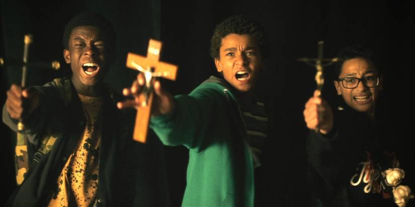 Jaden Michael, Gerald W. Jones III, and Gregory Diaz IV holding crucifixes in Vampires vs The Bronx