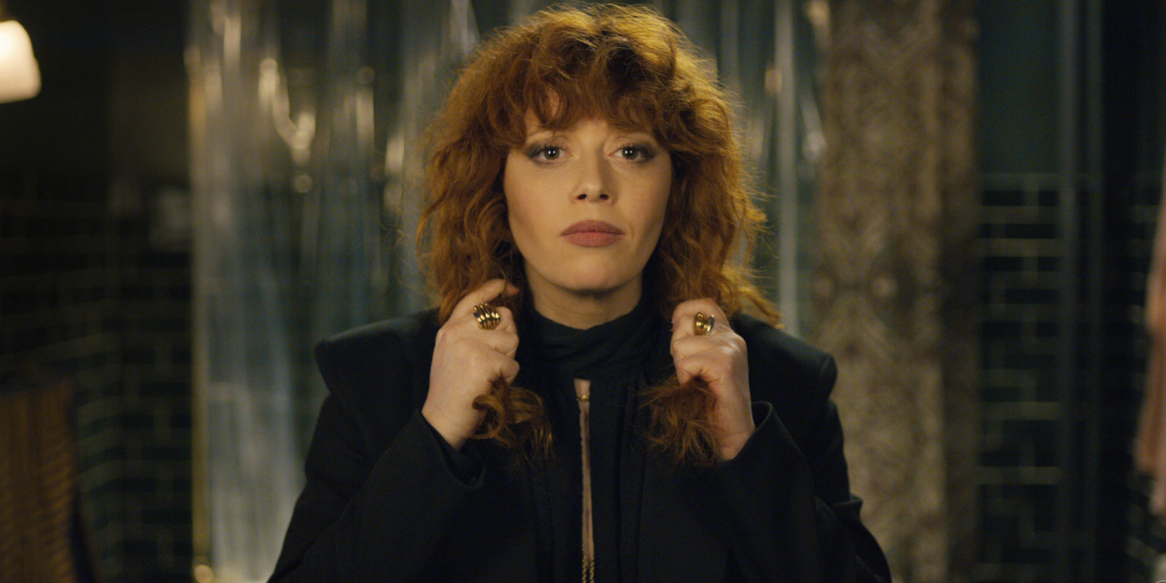 Nadia fixing her bowtie and looking in the mirror in Russian Doll.