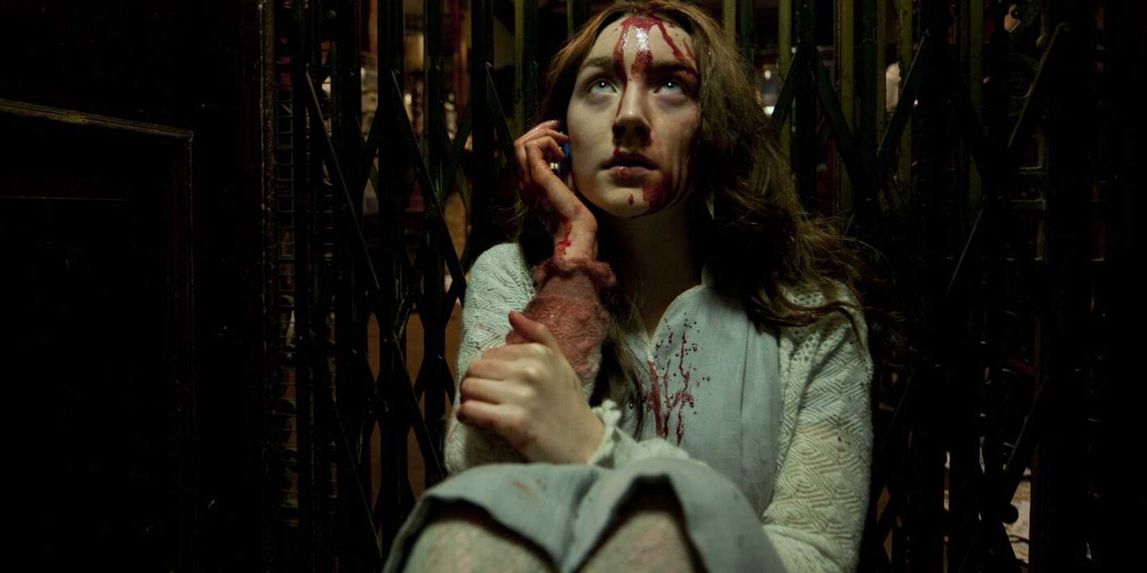 Saoirse Ronan covered in blood and sitting in an elevator in Byzantium