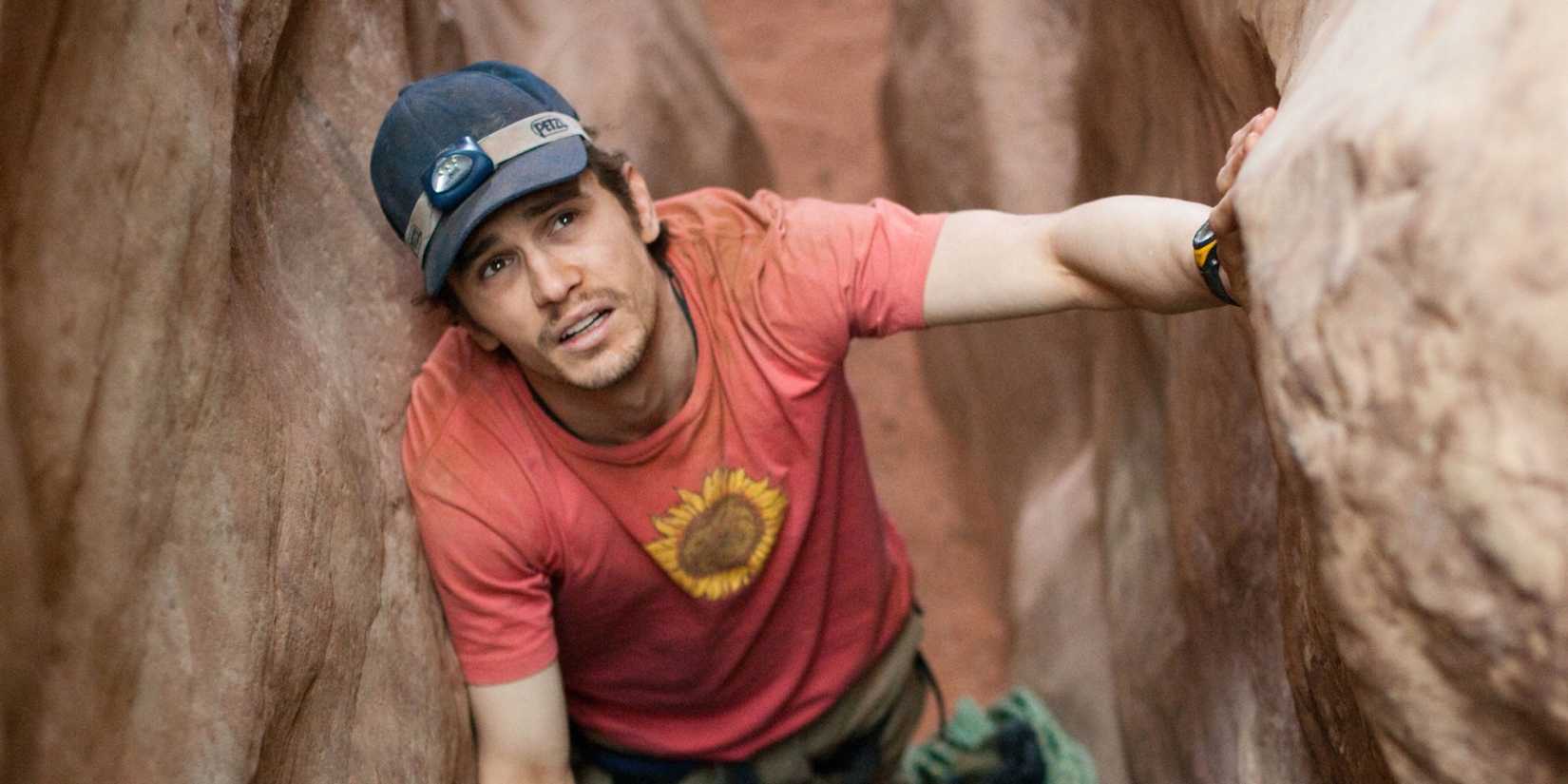 Aron Ralston (James Franco) looking up from a canyon in 127 Hours