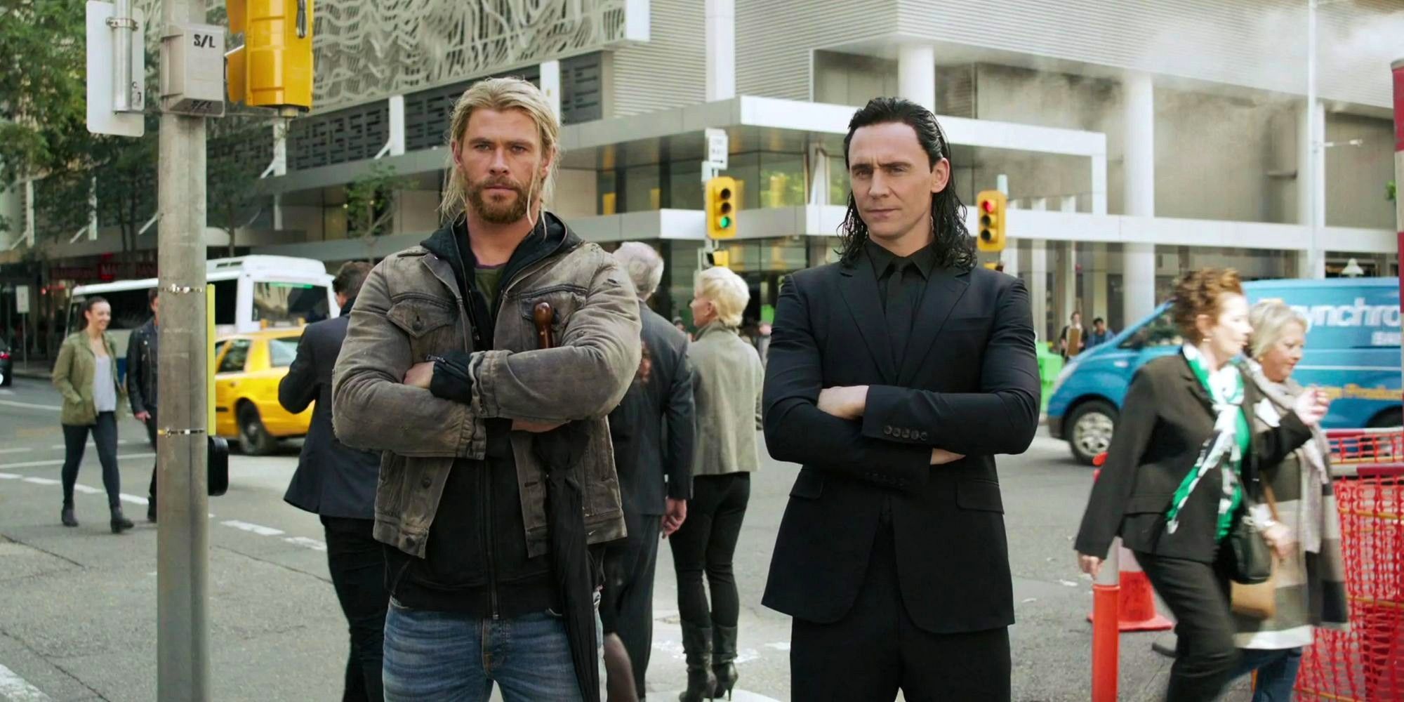 Chris Hemsworth and Tom Hiddleston as Thor and Loki standing by each other's side in Thor: Ragnarok