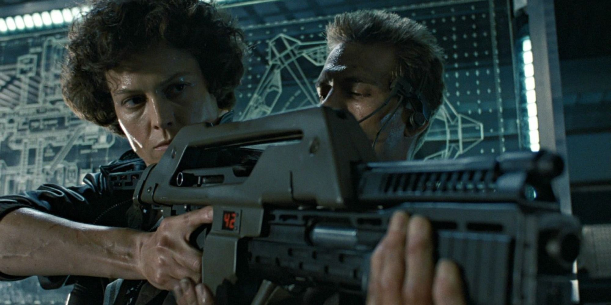 Sigourney Weaver holding a gun with Michael Biehn