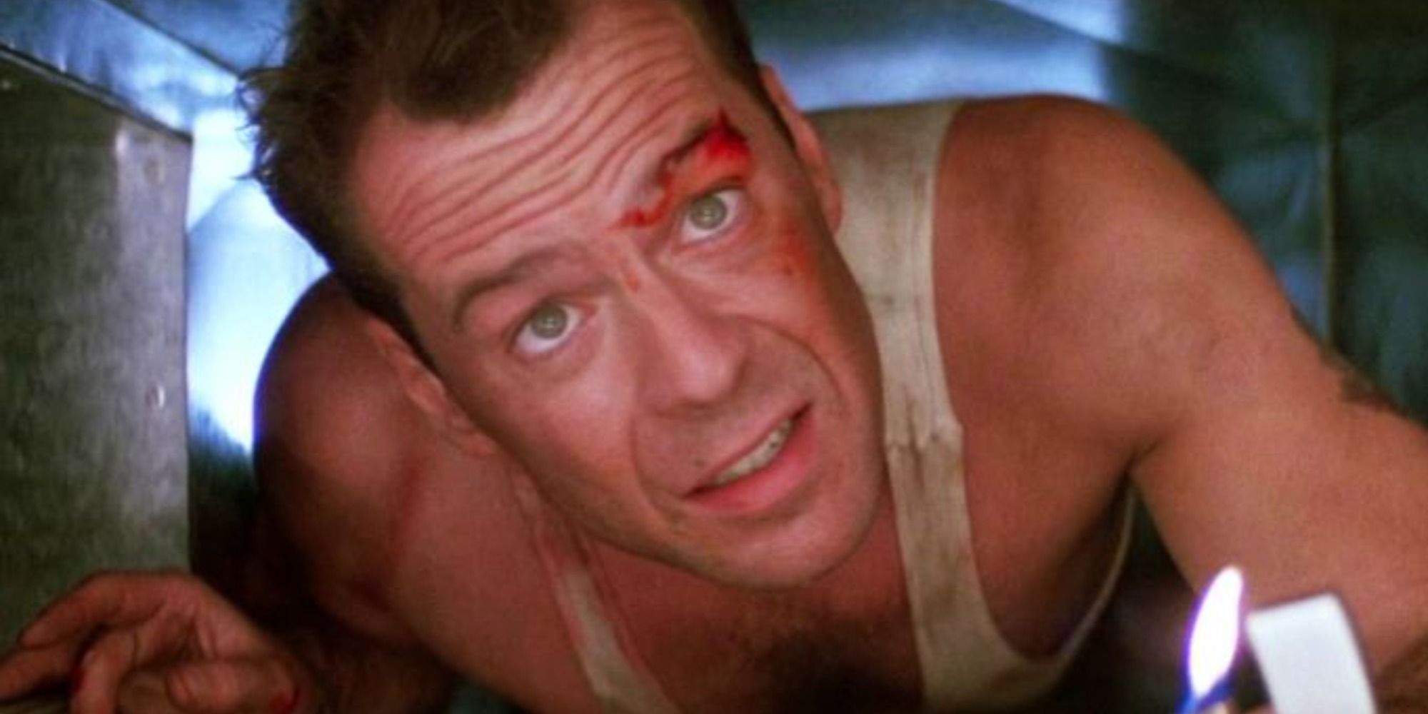 Bruce Willis as John McClane in the vents with a lighter
