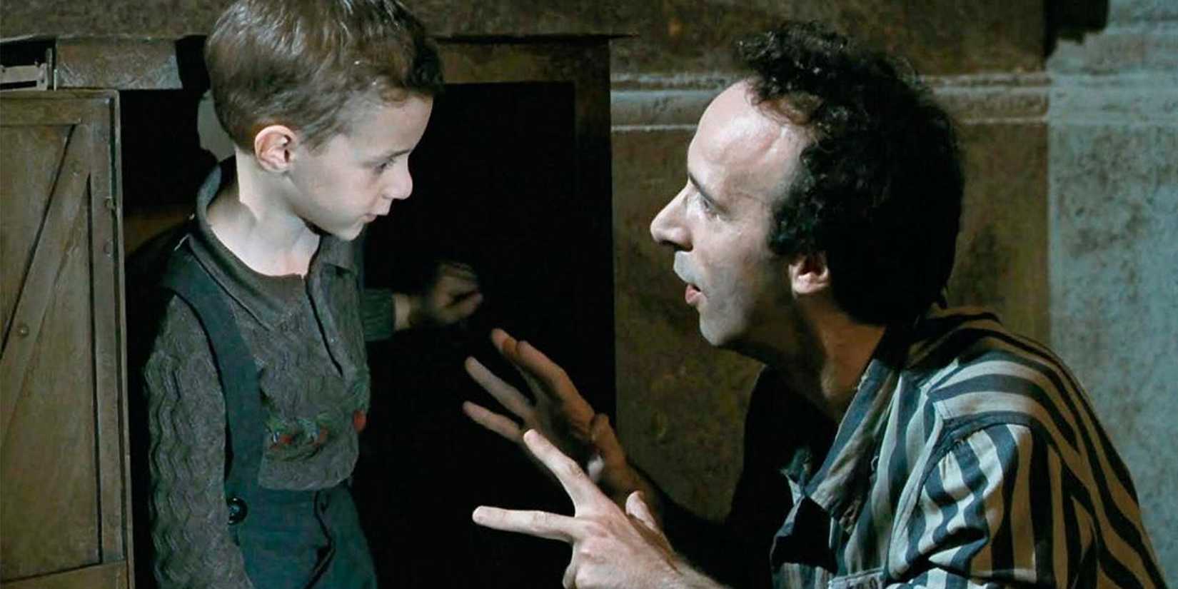 Roberto Benigni as Guido explaining something to his young son Giosué in Life is Beautiful.