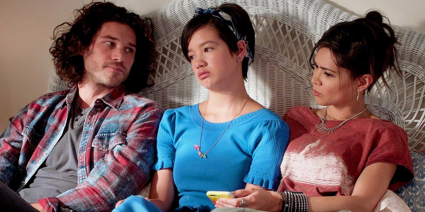 Bex and Bowie comfort Andi as they all sit together on a bed in Andi Mack.