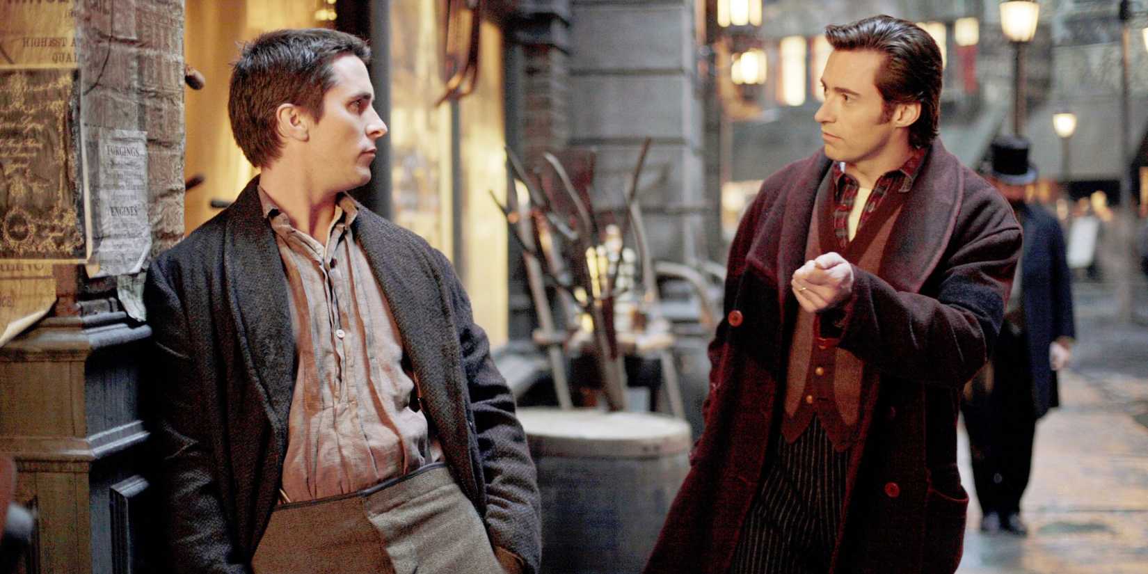 Christian Bale as Alfred talks to Hugh Jackman as Robert on the streets of 1890s London in The Prestige.