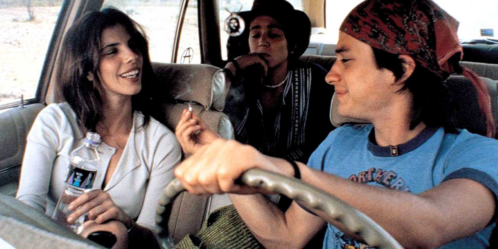 main characters of "Y Tu Mamá También", in a car, smoking a joint