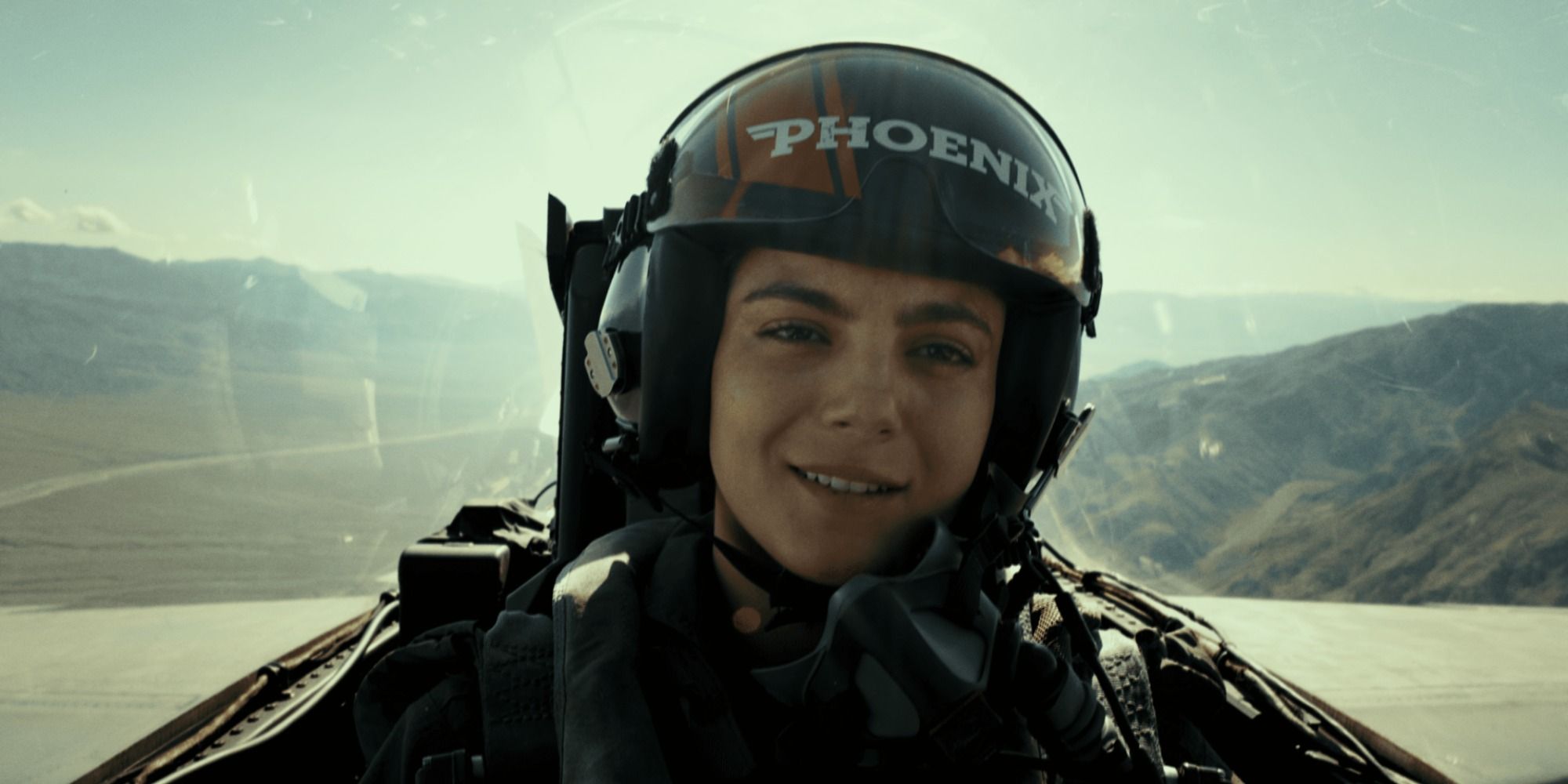 Monica Barbaro as Phoenix in the cockpit flying 
