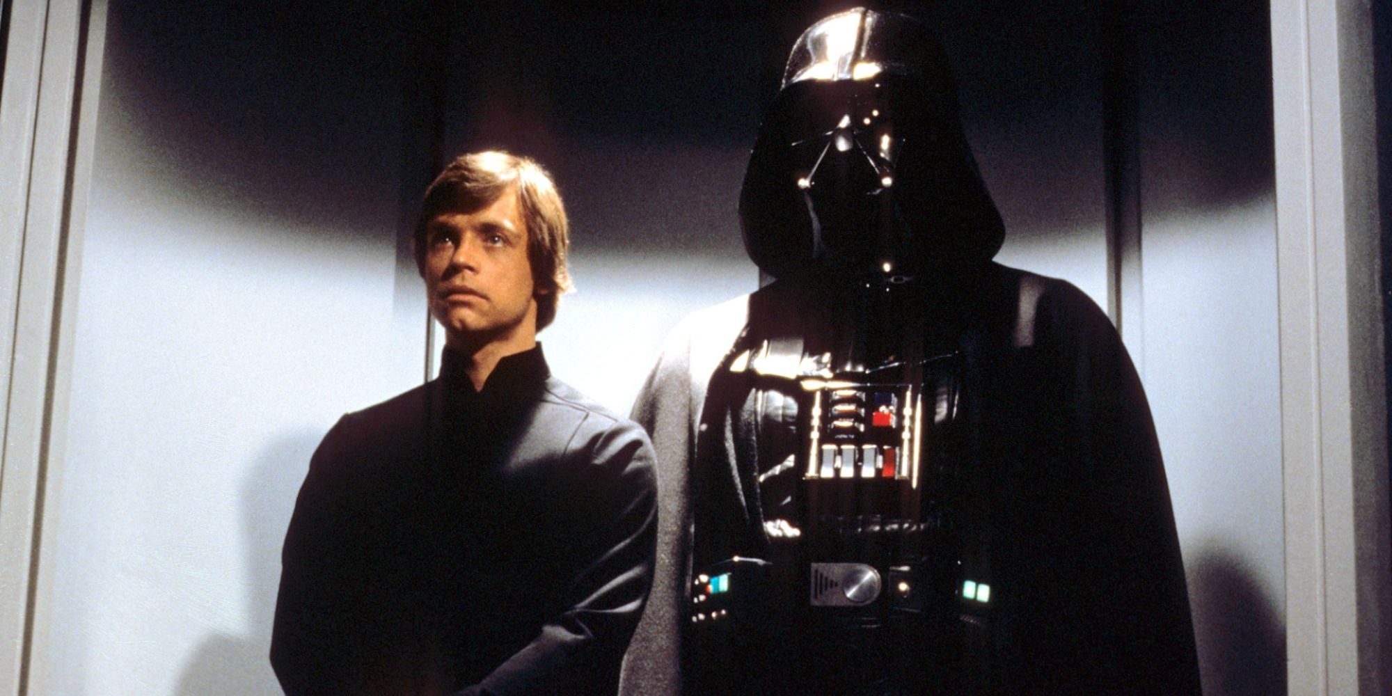 Luke Skywalker standing next to Darth Vader
