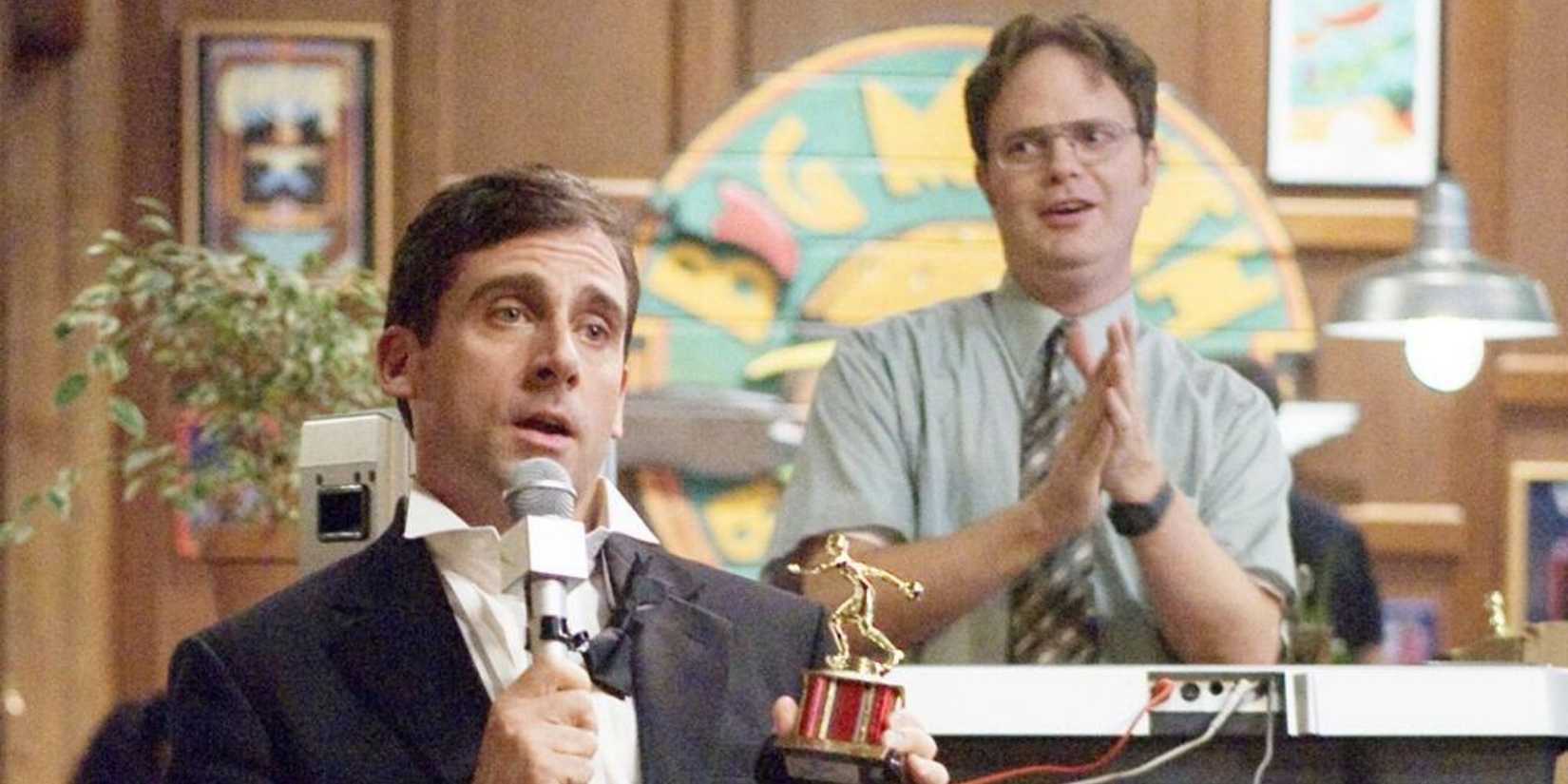 Michael presents a Dundie award and Dwight applauds in the background