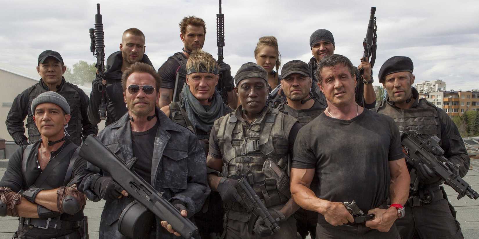 The cast of The Expendables 3 holding guns