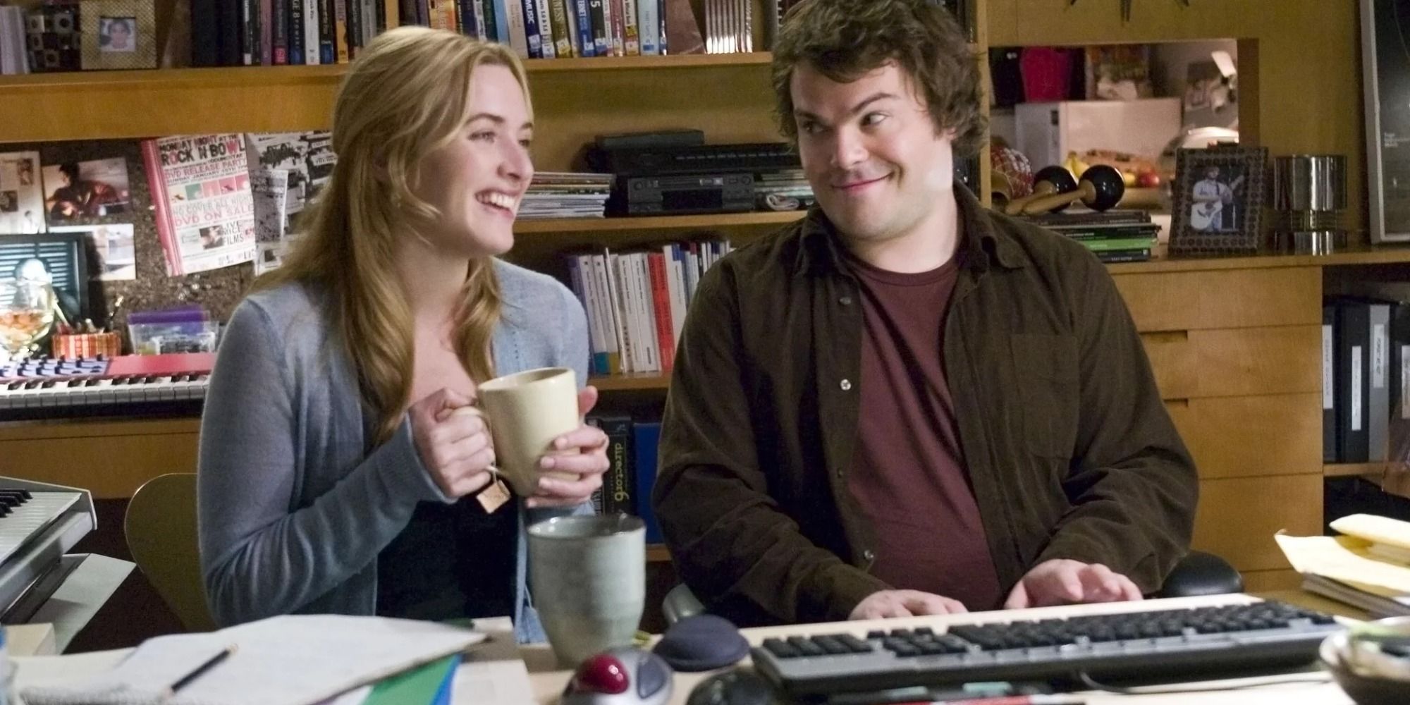 Kate Winslet drinking coffee and sitting beside Jack Black playing piano