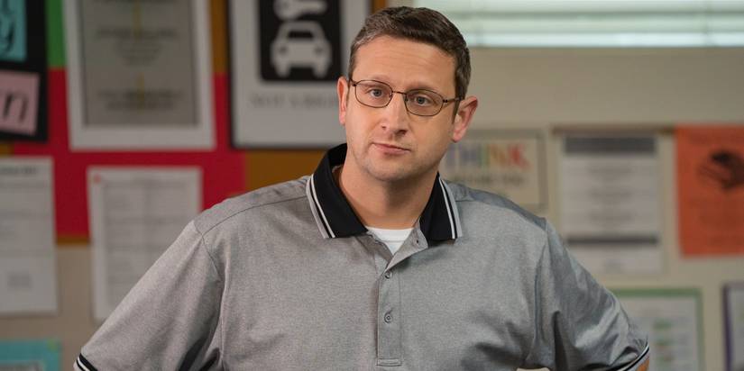 Tim Robinson in glasses and a gym shirt with his hands on his hips in I Think You Should Leave