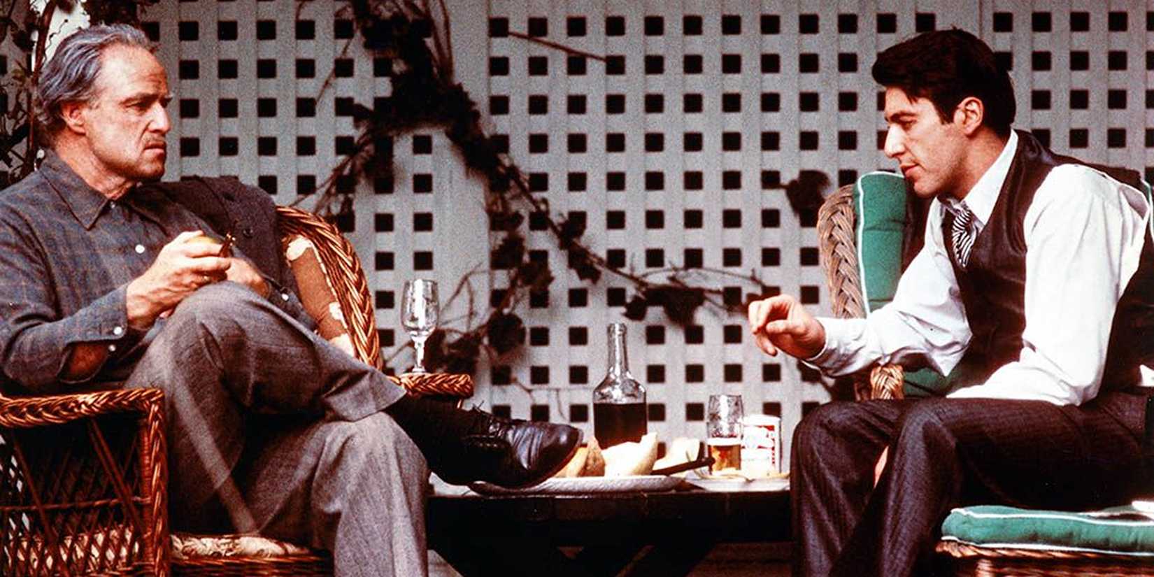 Vito and Michael Corleone from "The Godfather," sitting across each other